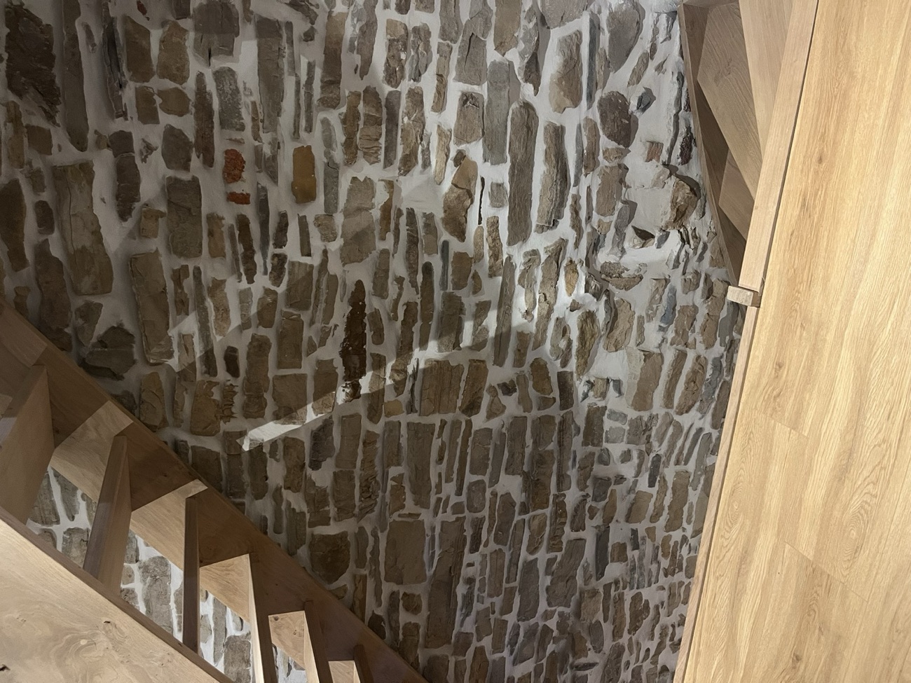Mur intérieur en pierre rejointoyé le long d'un escalier